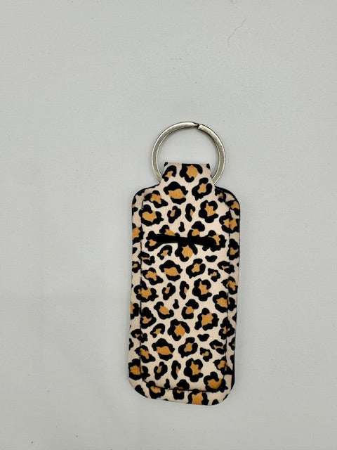 Cute pattern hand sanitizer keychain holder with fun designs clipped to a bag
