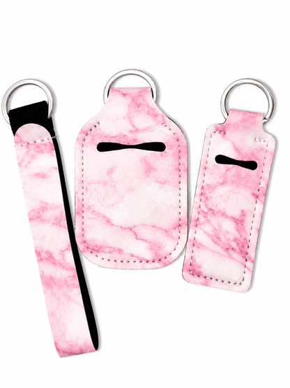 Matching gloss case, sanitizer holder, and wristlet keychain set with stylish prints