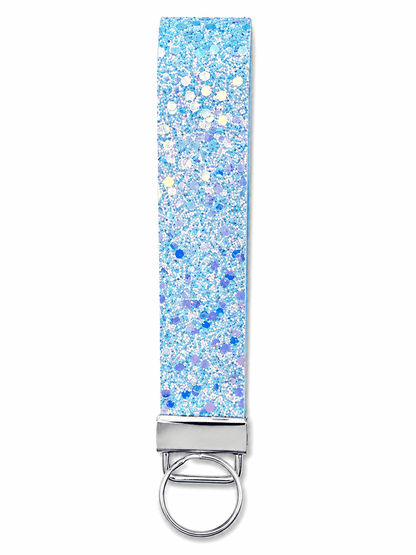 Printed wrist strap keychain with colorful playful patterns and metal clasp on white fabric