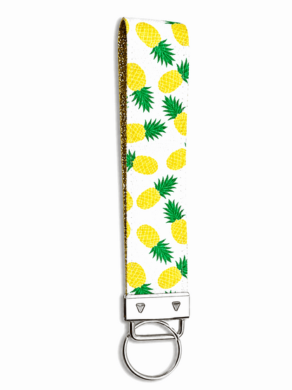 White printed wrist strap keychain with colorful playful patterns and metal clasp