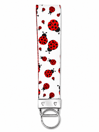 Printed wrist strap keychain with colorful playful patterns and metal clasp