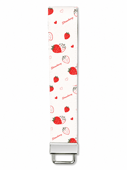 White printed wrist strap keychain with colorful heart, lips, and cupcake patterns and metal clasp